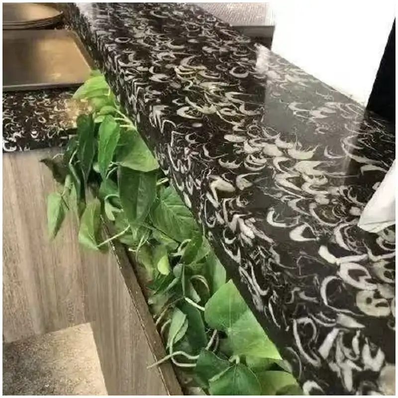 Fossil Black Marble bar tops in a luxury villa with dark fossil patterned stone surfaces