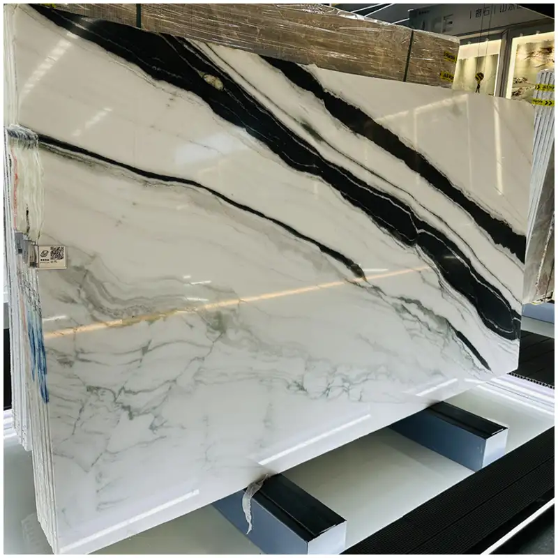 Chinese-Panda-Marble-Slabs Esta Stone Chinese Panda White Marble slab displaying thick black bands and wavy grey veins on polished white surface.