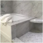 Carrara Marble Tub Surround: Panel Layout, Deck Cutouts, Warm Light, and Wet Edges