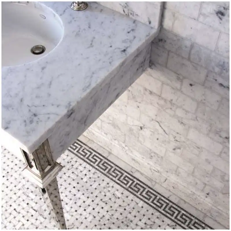 Carrara marble backsplash aligned with a vanity mirror outlet and vein direction Carrara marble backsplash aligned with a vanity mirror outlet and vein direction
