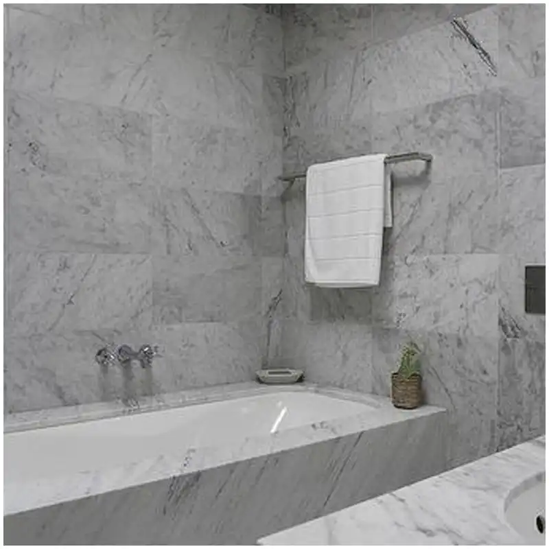 Carrara marble tub surround panels aligned with deck cutouts and warm bathroom light Carrara marble tub surround panels aligned with deck cutouts and warm bathroom light