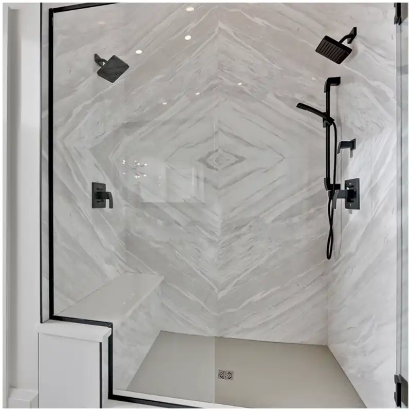 Volakas marble batch matching with grey vein direction checked across dry laid hotel bathroom wall and floor panels Volakas marble batch matching with grey vein direction checked across dry laid hotel bathroom wall and floor panels