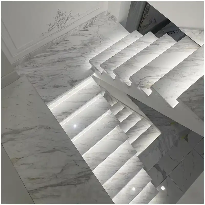 Volakas marble skirting at a white marble bathroom floor to wall transition Volakas marble skirting at a white marble bathroom floor to wall transition